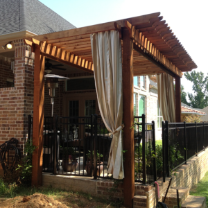 A large wooden shade structure overhanging a back porch.