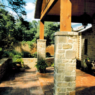 A freshly redesigned back yard porch featuring intricate stone and brickwork.
