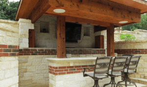 An exquisite outdoor backyard bar made of brick and wood.